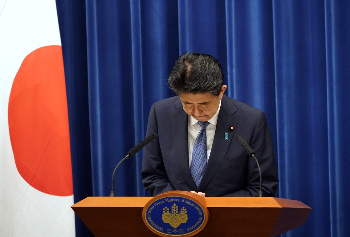 8月28日,日本首相安倍晋三在东京出席记者会时鞠躬.